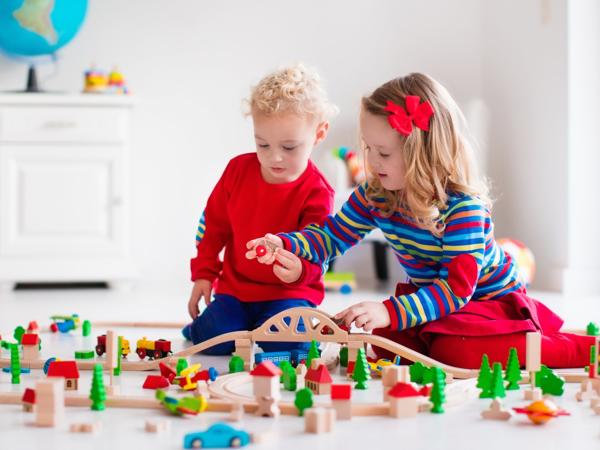 Children playing with wooden train