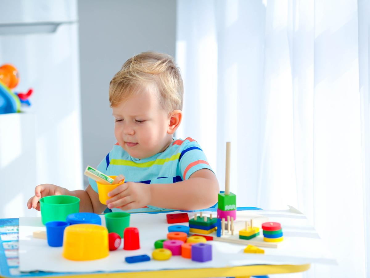 Child playing with colorful building blocks