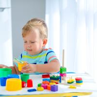 Child playing with colorful building blocks