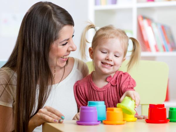 Mother and daughter playing with stacking cups