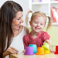 Mother and daughter playing with stacking cups