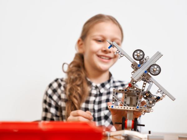 Girl building robot