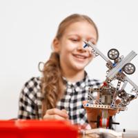 Girl building robot